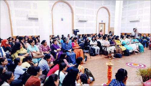 Seated audience listening to a speaker