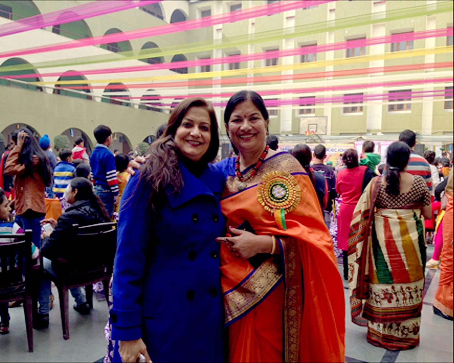 Two women standing next to each other and smiling