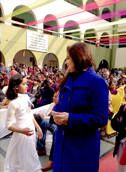 A woman interacting with a girl in a school