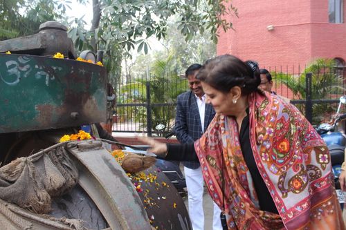 Mrs. Lalita Nijhawan and others participating in a ceremony to start road development work