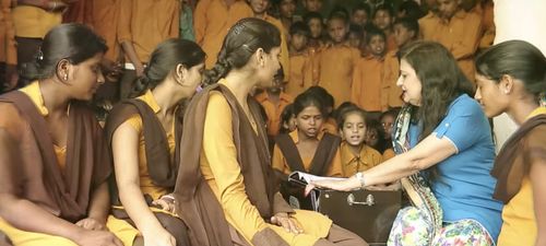 Mrs. Lalita Nijhawan teaching music to the children