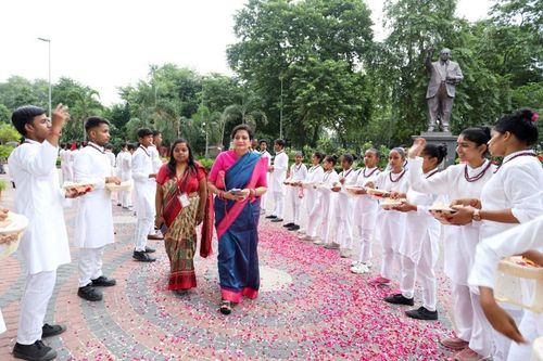 Children showering petals on Mrs. Lalita Nijhawan to welcome her